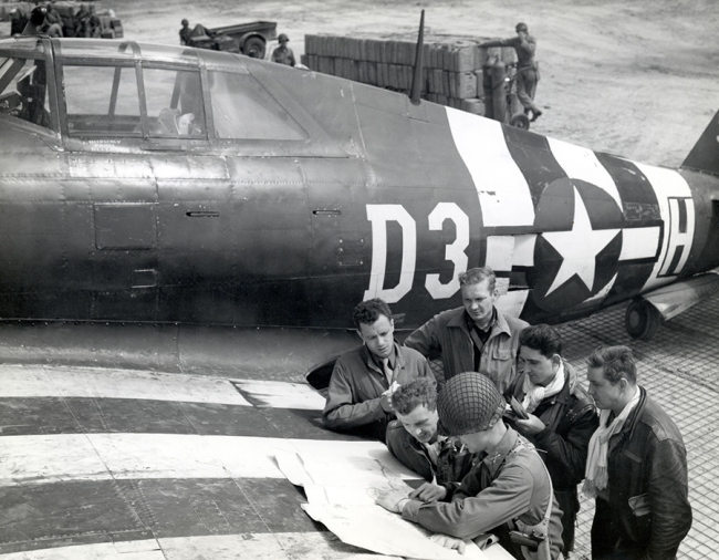 P-47 fighter-bomber pilots at a rough airstrip near St. Mere Eglise